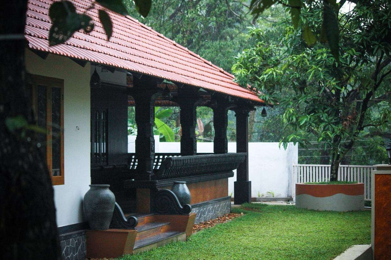 A traditional Kerala verandah with wooden pillars, a calm space for creative sessions