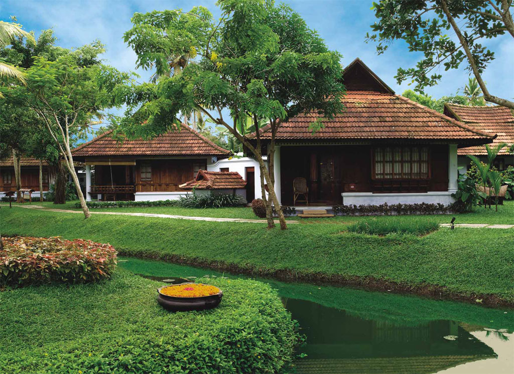 Illustrative property imagery: tiled-roof heritage cottages set in a manicured tropical garden beside a narrow green canal
