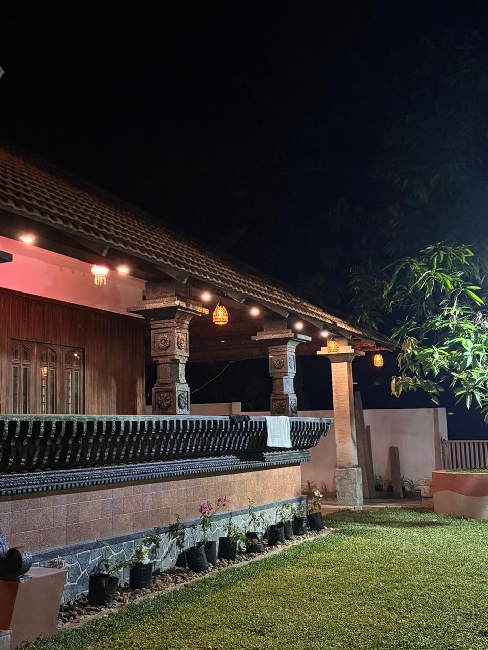 The house lit warmly after dark