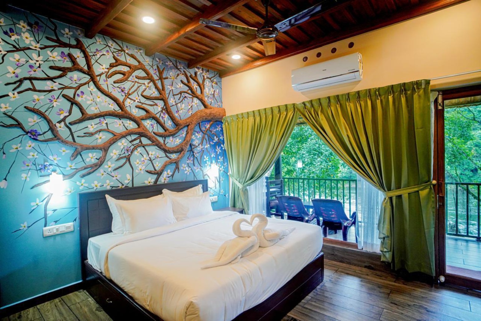 Riverfront family room with a hand-painted blossom tree mural and doors opening onto a private balcony